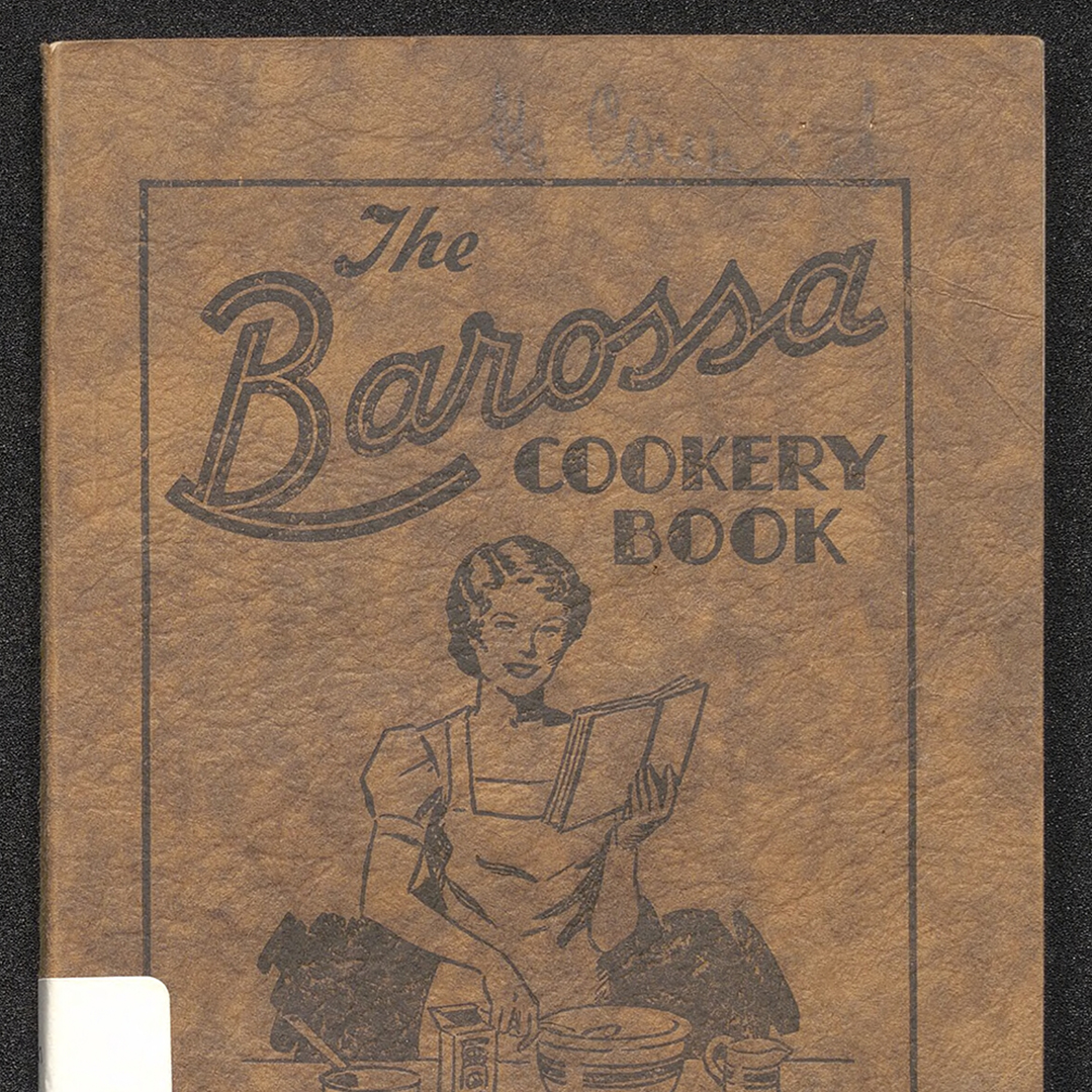 Cover of The Barossa Cookery Book, featuring an illustration of a women holding a book while mixing milk, flour and eggs in a bowl