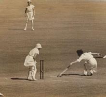 Five women playing cricket
